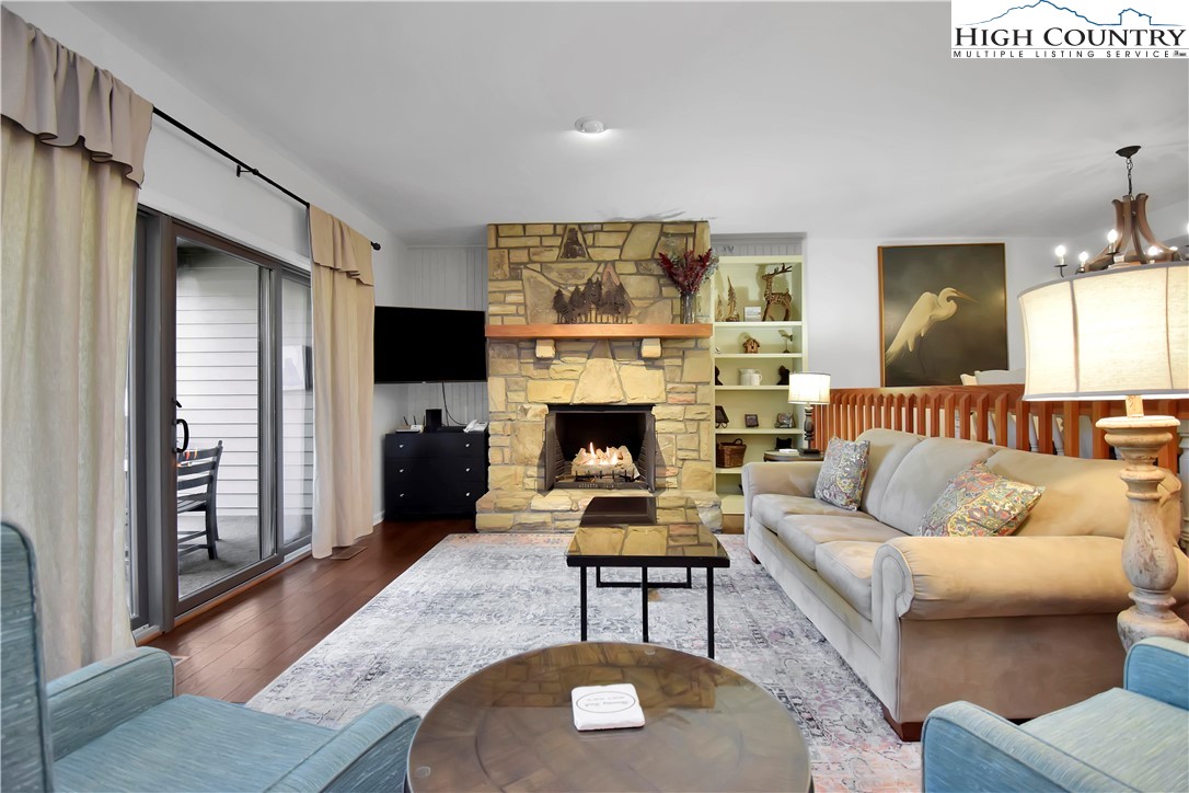 140 Manor View Lane, Unit CASCADES 2 Blowing Rock, NC 28605 - Photo 24 of 25 a living room with furniture a flat screen tv and a fireplace