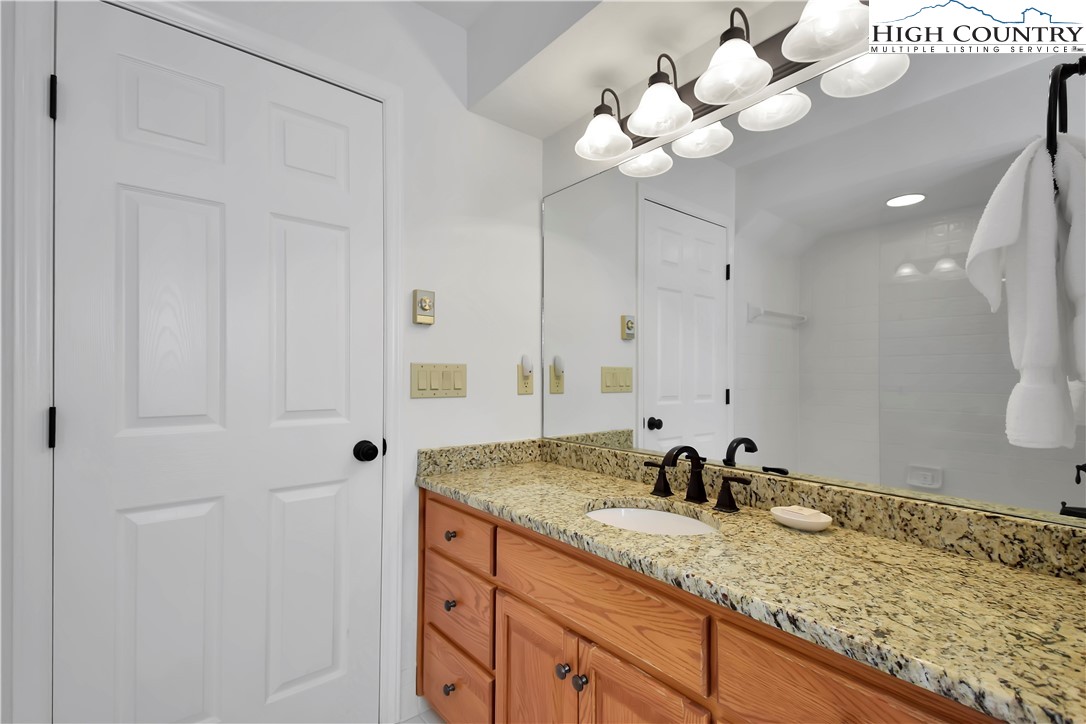 140 Manor View Lane, Unit CASCADES 2 Blowing Rock, NC 28605 - Photo 6 of 25 a bathroom with a sink vanity and a mirror