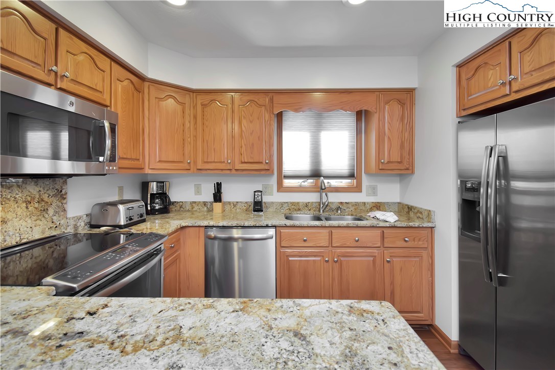 140 Manor View Lane, Unit CASCADES 2 Blowing Rock, NC 28605 - Photo 8 of 25 a kitchen with stainless steel appliances granite countertop a sink stove and refrigerator