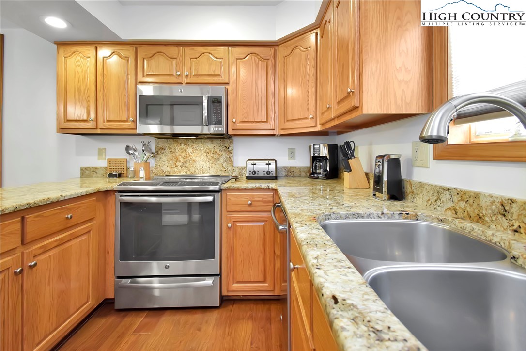 140 Manor View Lane, Unit CASCADES 2 Blowing Rock, NC 28605 - Photo 9 of 25 a kitchen with stainless steel appliances granite countertop a sink and a stove