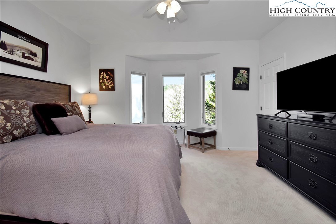 140 Manor View Lane, Unit CASCADES 2 Blowing Rock, NC 28605 - Photo 10 of 25 a bedroom with a bed and a flat screen tv