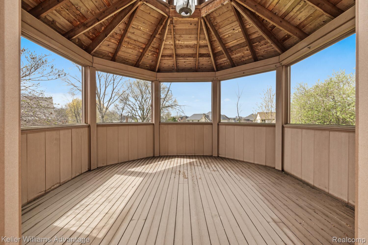 4100 Norwich Court Rochester, MI 48306 - Photo 60 of 72 Unfurnished sunroom with a wooden deck, a sauna / steam room, lofted ceiling with beams, and a gazebo