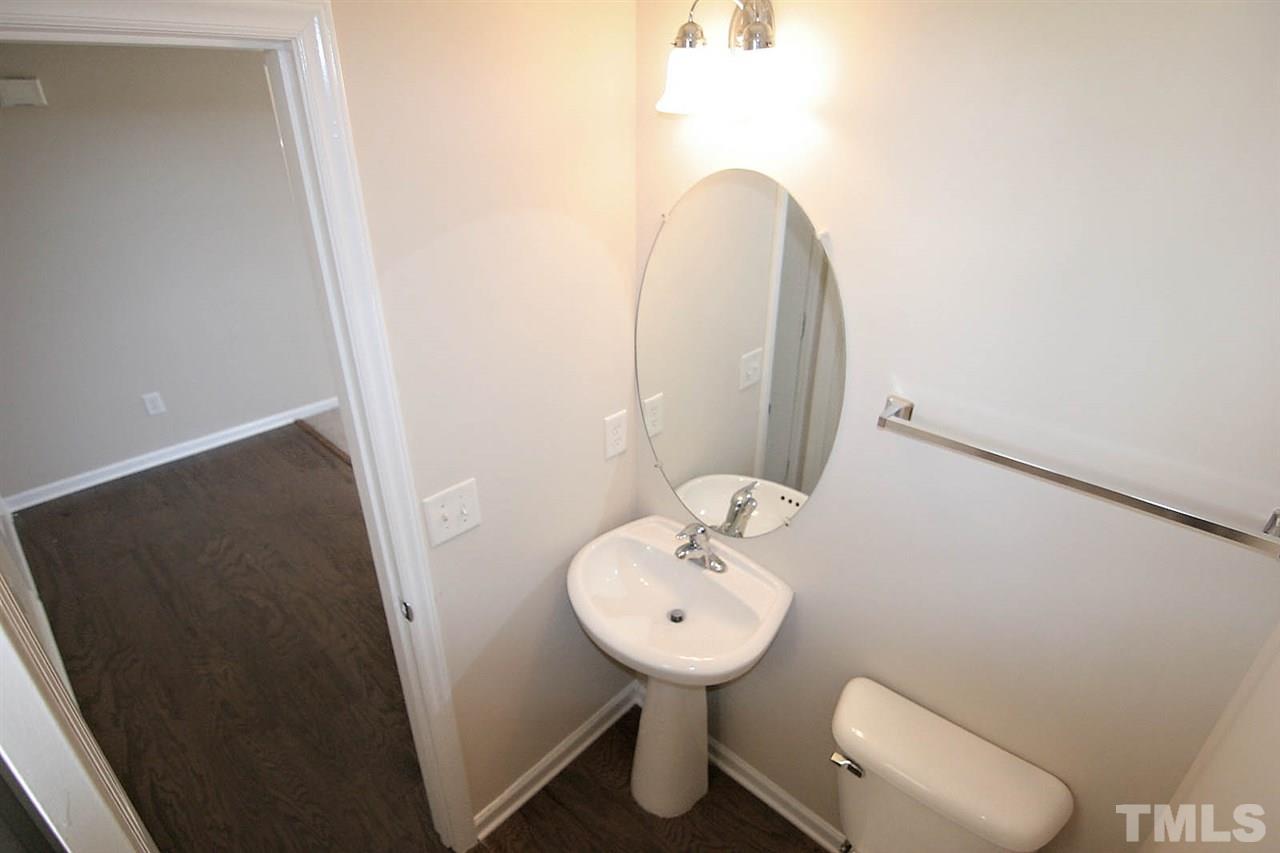 3715 Horseshoe Farm Street Raleigh, NC 27610 - Photo 11 of 18 a bathroom with a sink toilet and a mirror