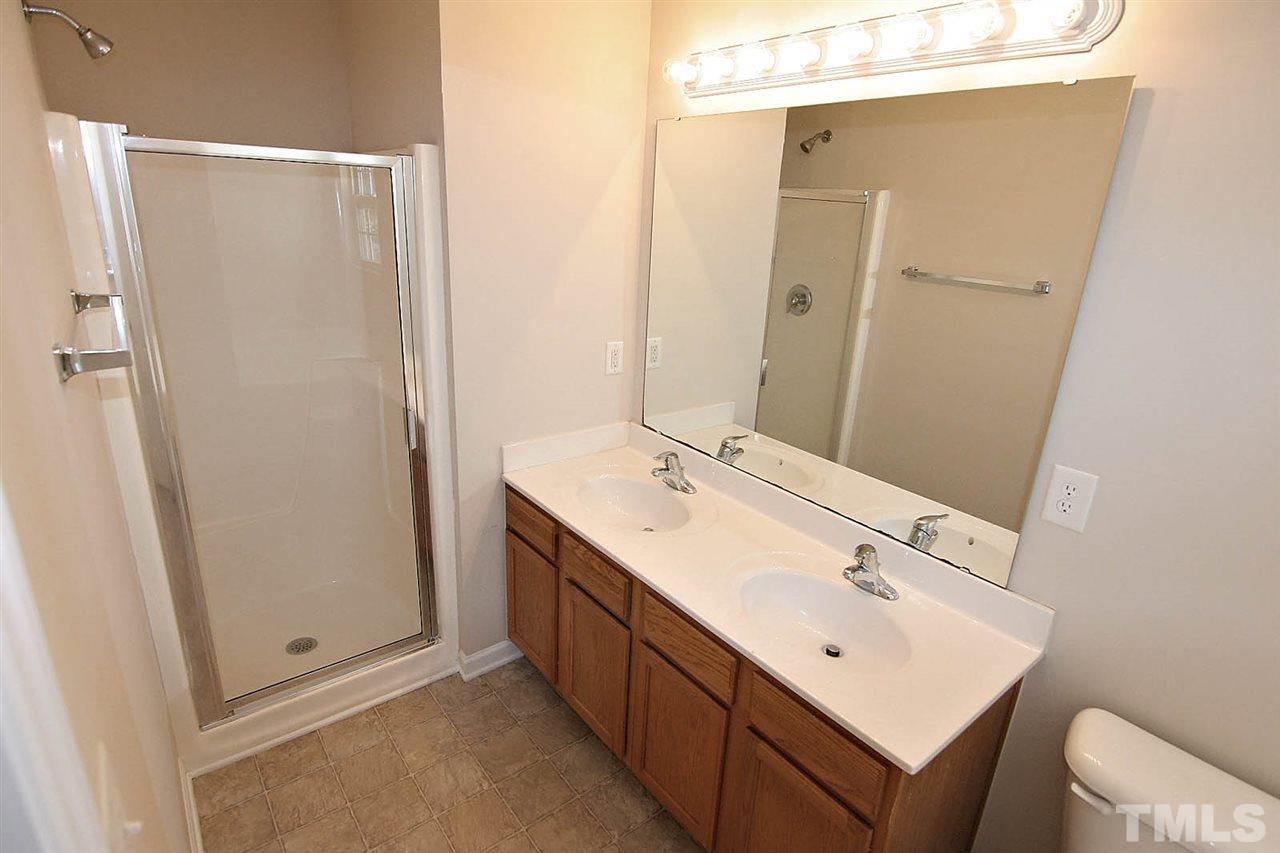 3715 Horseshoe Farm Street Raleigh, NC 27610 - Photo 13 of 18 a bathroom with a double vanity sink mirror and toilet