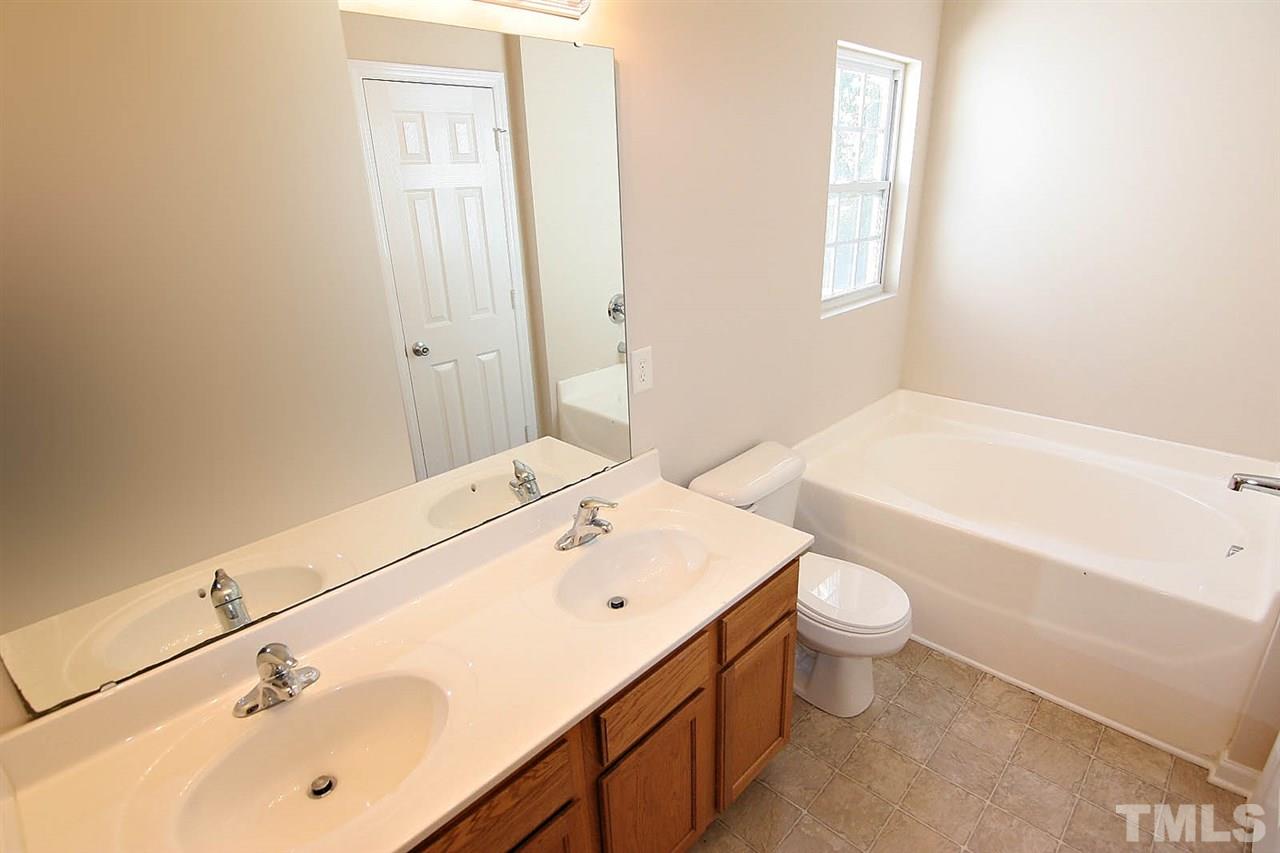 3715 Horseshoe Farm Street Raleigh, NC 27610 - Photo 14 of 18 a bathroom with a sink a toilet and bathtub