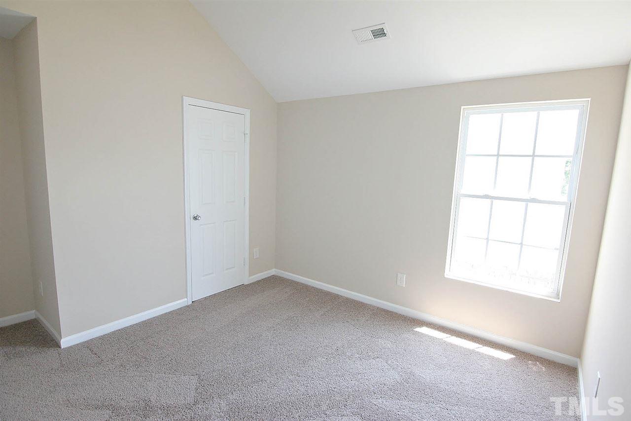 3715 Horseshoe Farm Street Raleigh, NC 27610 - Photo 15 of 18 an empty room with a window