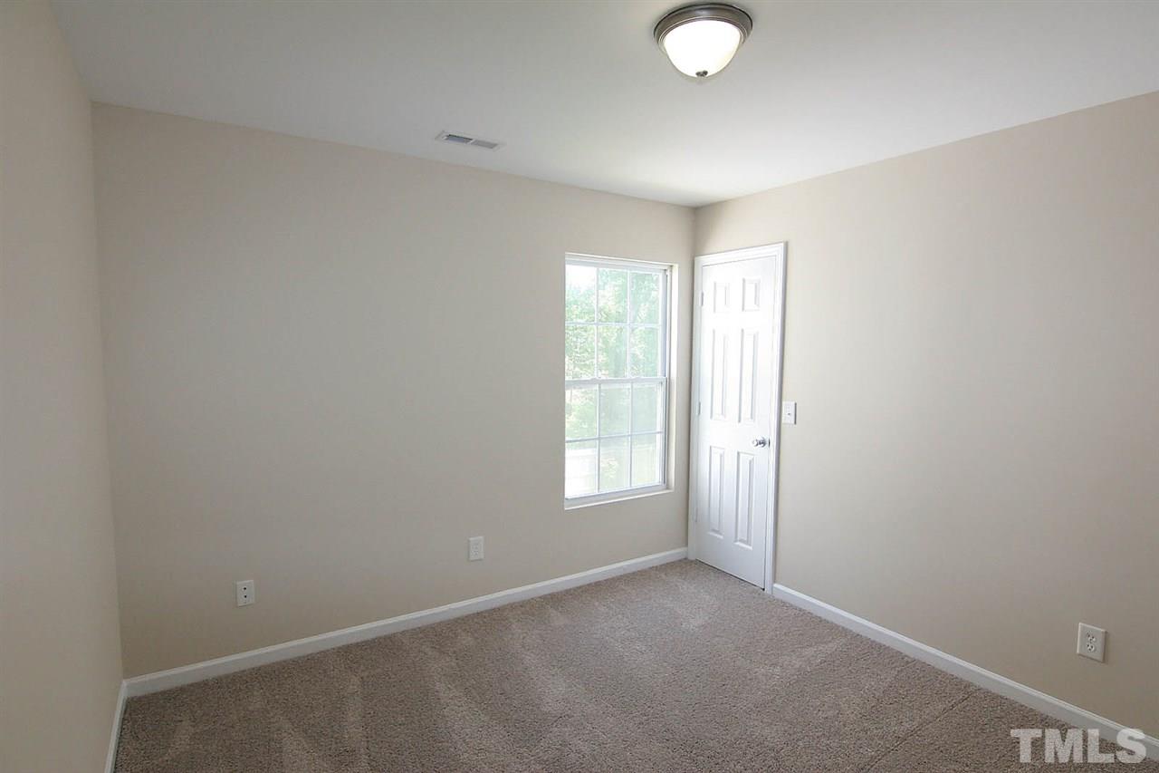 3715 Horseshoe Farm Street Raleigh, NC 27610 - Photo 17 of 18 an empty room with windows and closet