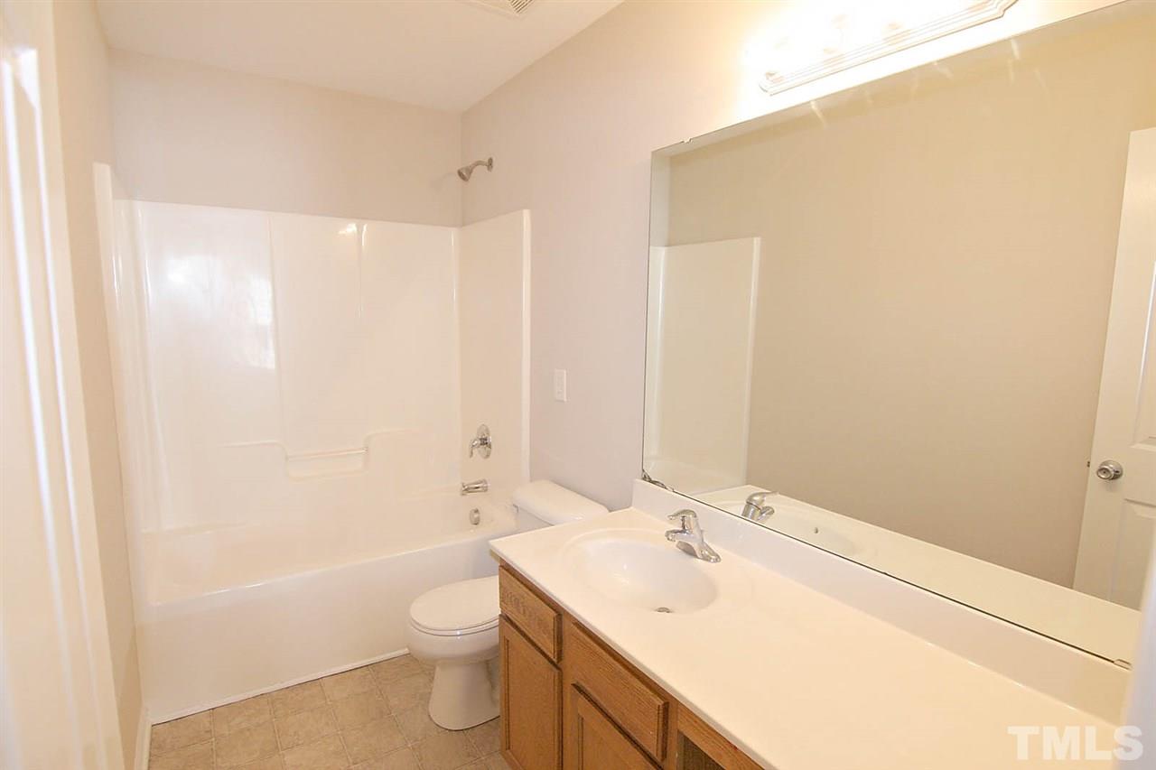 3715 Horseshoe Farm Street Raleigh, NC 27610 - Photo 18 of 18 a bathroom with a sink a toilet and shower
