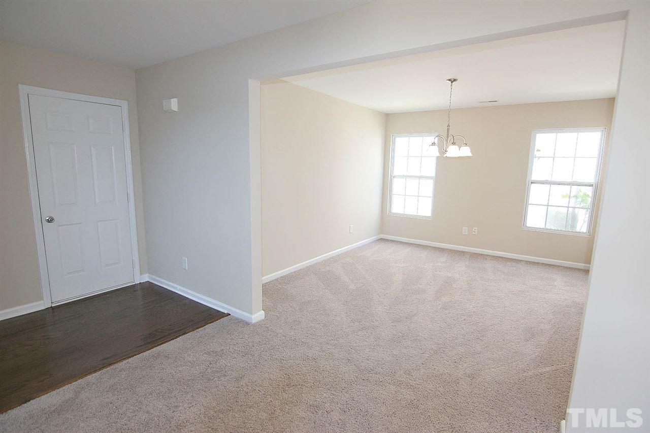 3715 Horseshoe Farm Street Raleigh, NC 27610 - Photo 3 of 18 an empty room with chandelier fan and windows