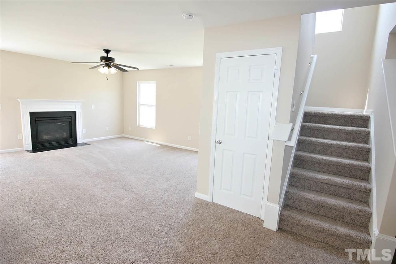 3715 Horseshoe Farm Street Raleigh, NC 27610 - Photo 4 of 18 a view of an empty room with a ceiling fan