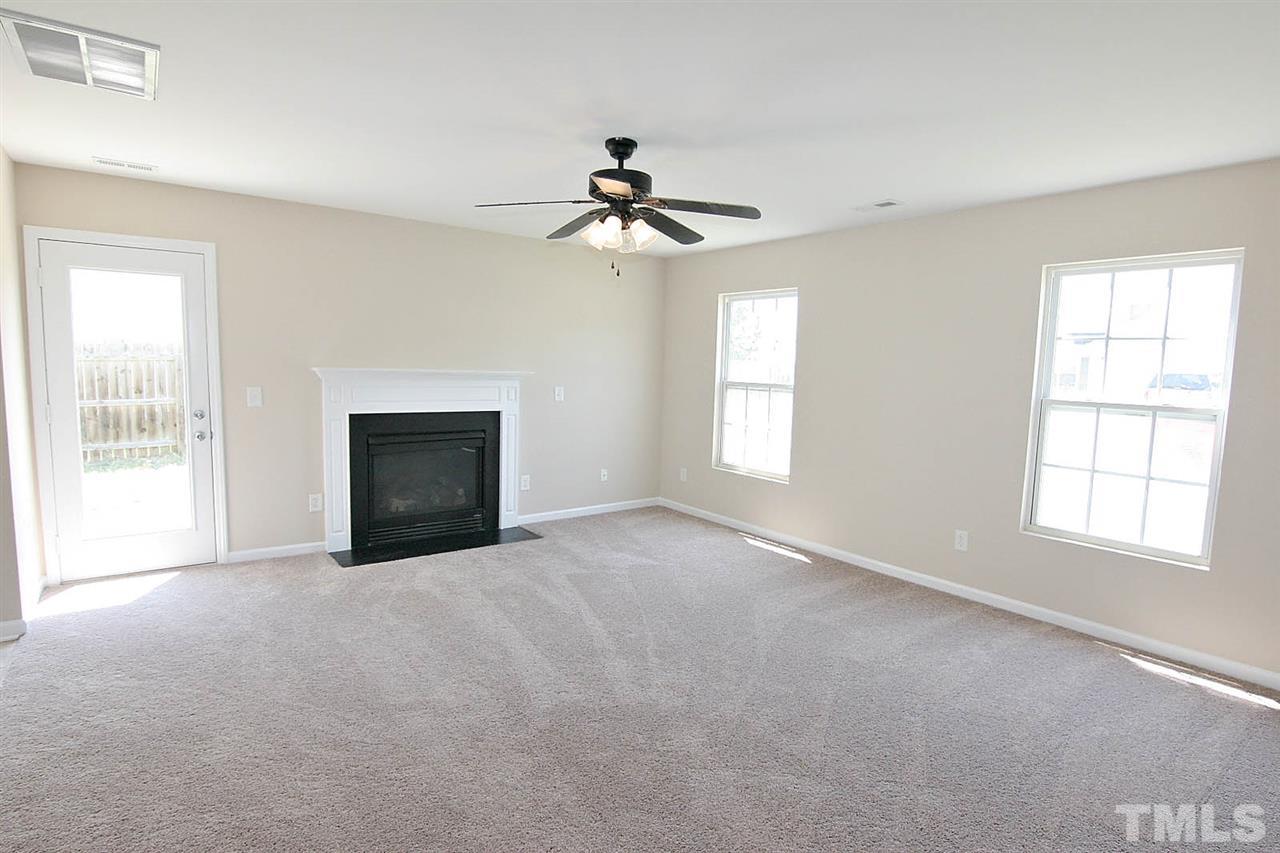 3715 Horseshoe Farm Street Raleigh, NC 27610 - Photo 6 of 18 an empty room with windows and chandelier fan