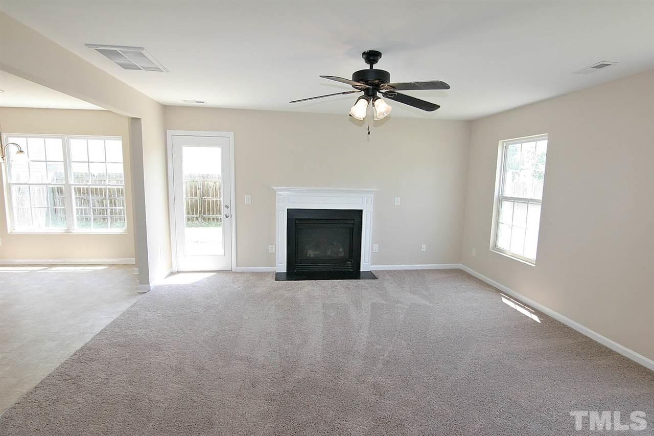 3715 Horseshoe Farm Street Raleigh, NC 27610 - Photo 7 of 18 a view of an empty room with window and fire place