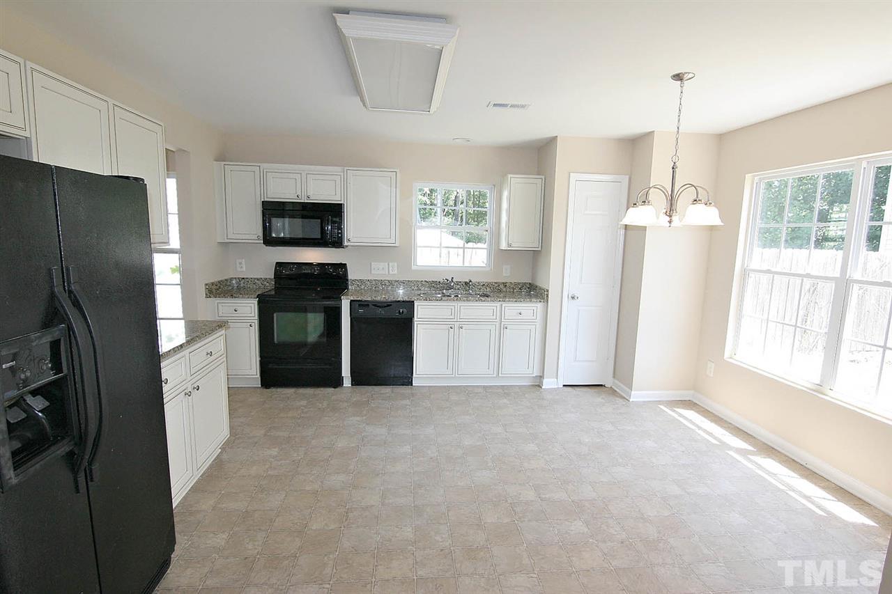 3715 Horseshoe Farm Street Raleigh, NC 27610 - Photo 8 of 18 a kitchen with refrigerator cabinets and furniture