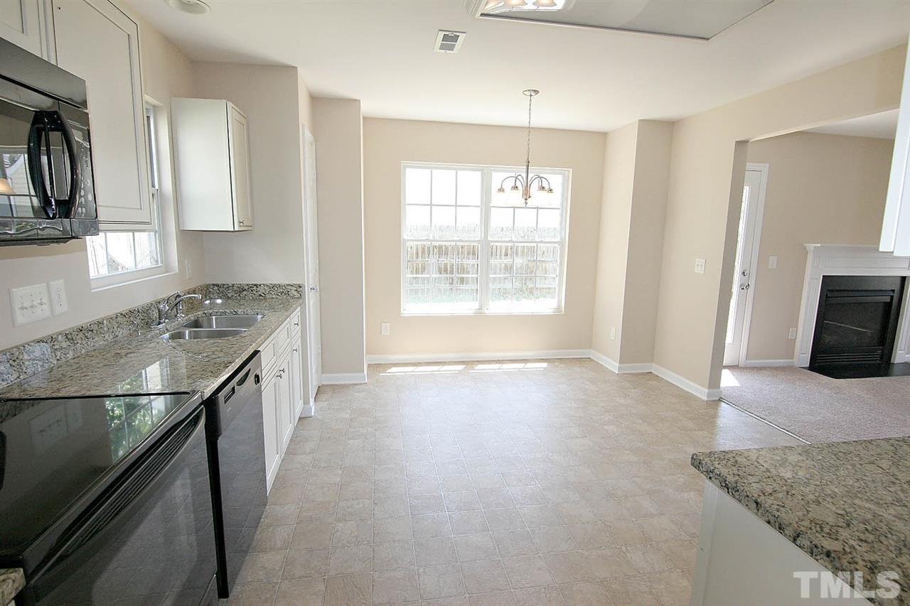 3715 Horseshoe Farm Street Raleigh, NC 27610 - Photo 9 of 18 a kitchen with stainless steel appliances granite countertop a sink stove and refrigerator