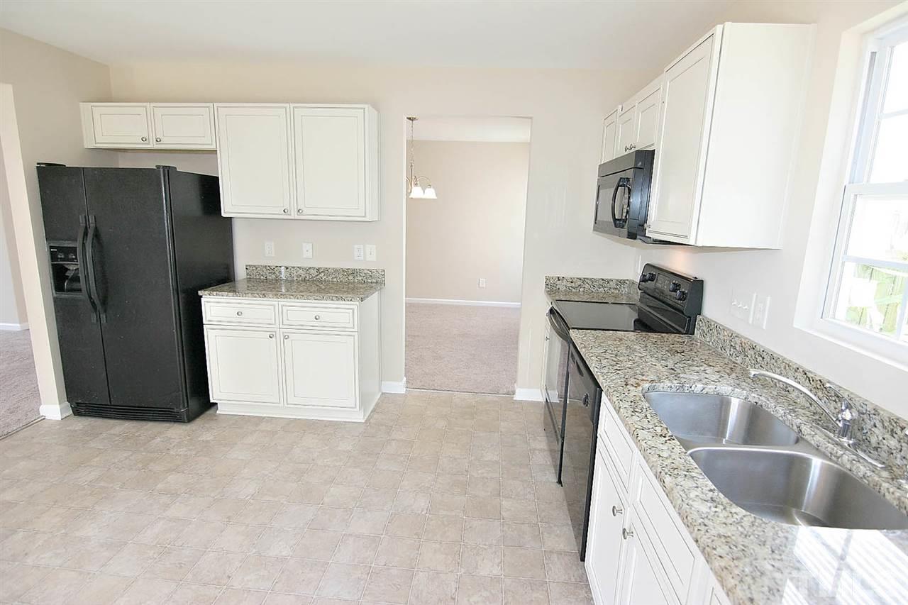3715 Horseshoe Farm Street Raleigh, NC 27610 - Photo 10 of 18 a kitchen with stainless steel appliances granite countertop a sink stove and refrigerator
