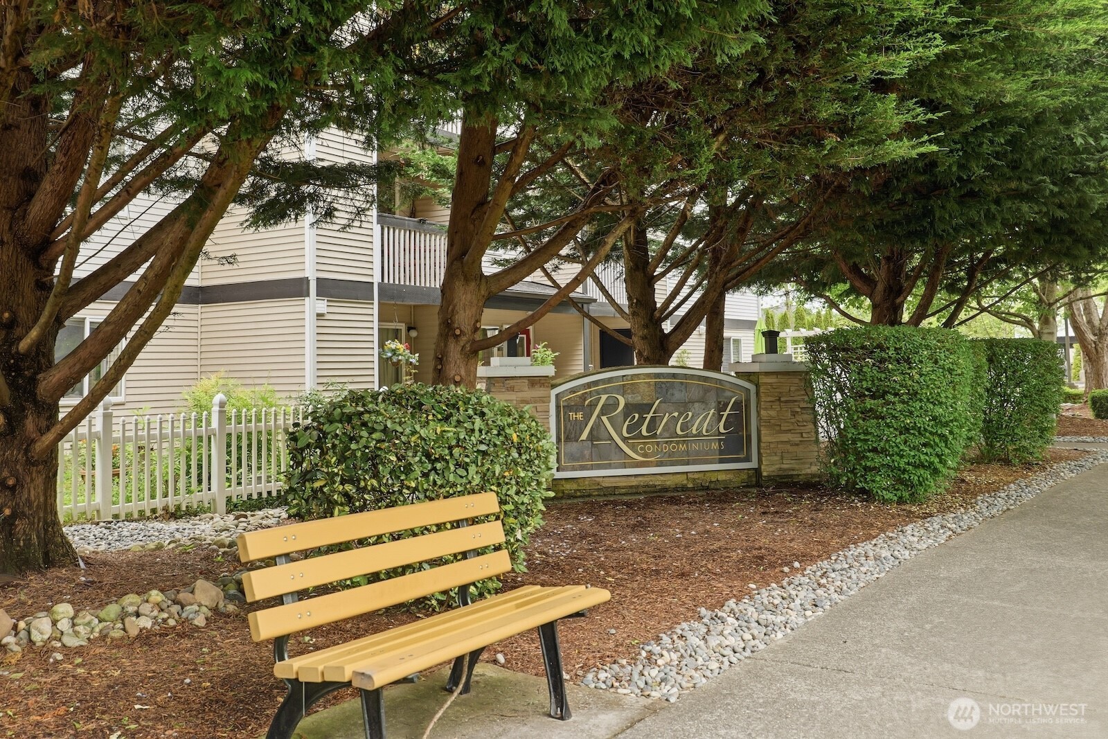 16409 Currie Road Southeast, Unit A308 Monroe, WA 98272 - Photo 20 of 21 a view of a street with potted plants and large trees