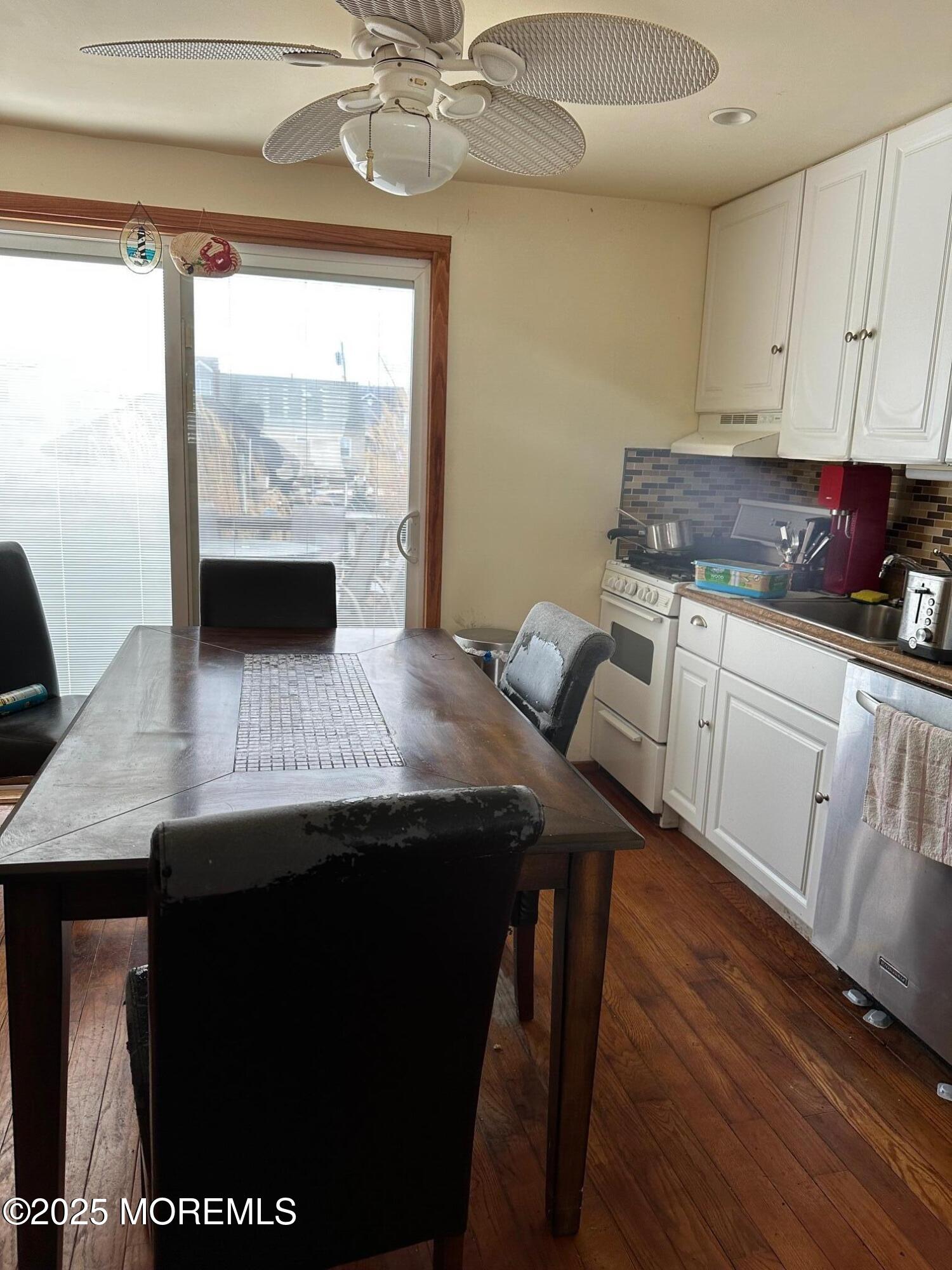 41 Frank Drive Beach Haven West, NJ 08050 - Photo 5 of 10 a kitchen with a table chairs and white cabinets