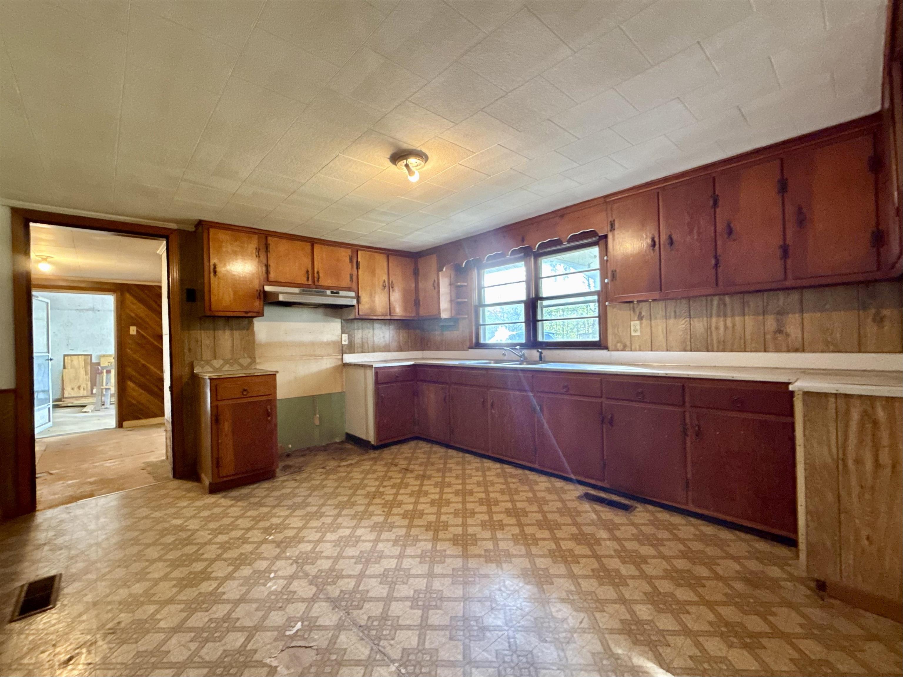 845 Needham Road Drummonds, TN 38023 - Photo 17 of 22 Kitchen with light floors, wood walls, light countertops, and wood finish cabinets