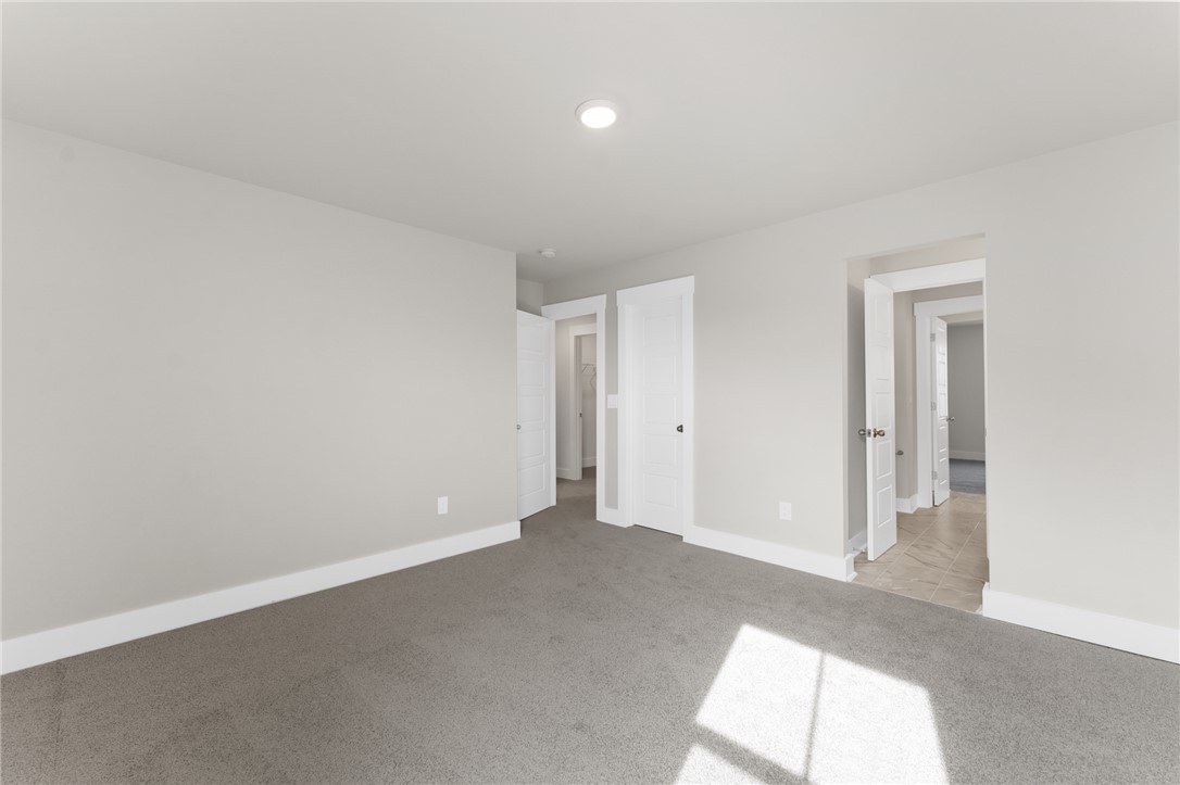 167 Tiger Lily Drive Anderson, SC 29621 - Photo 27 of 34 A spacious, naturally illuminated room featuring plush carpeting and modern recessed lighting.