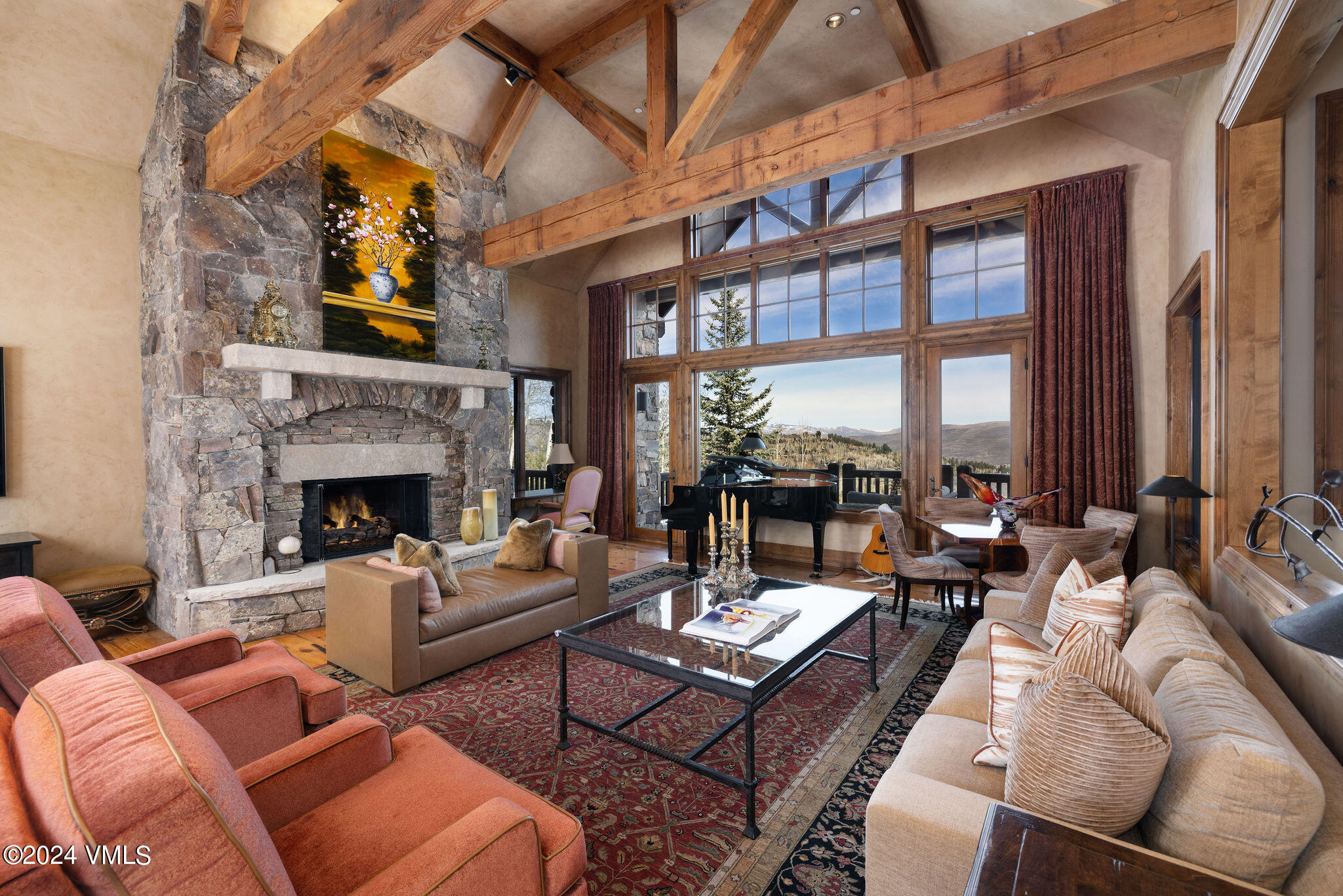 a living room with furniture a fireplace and a large window