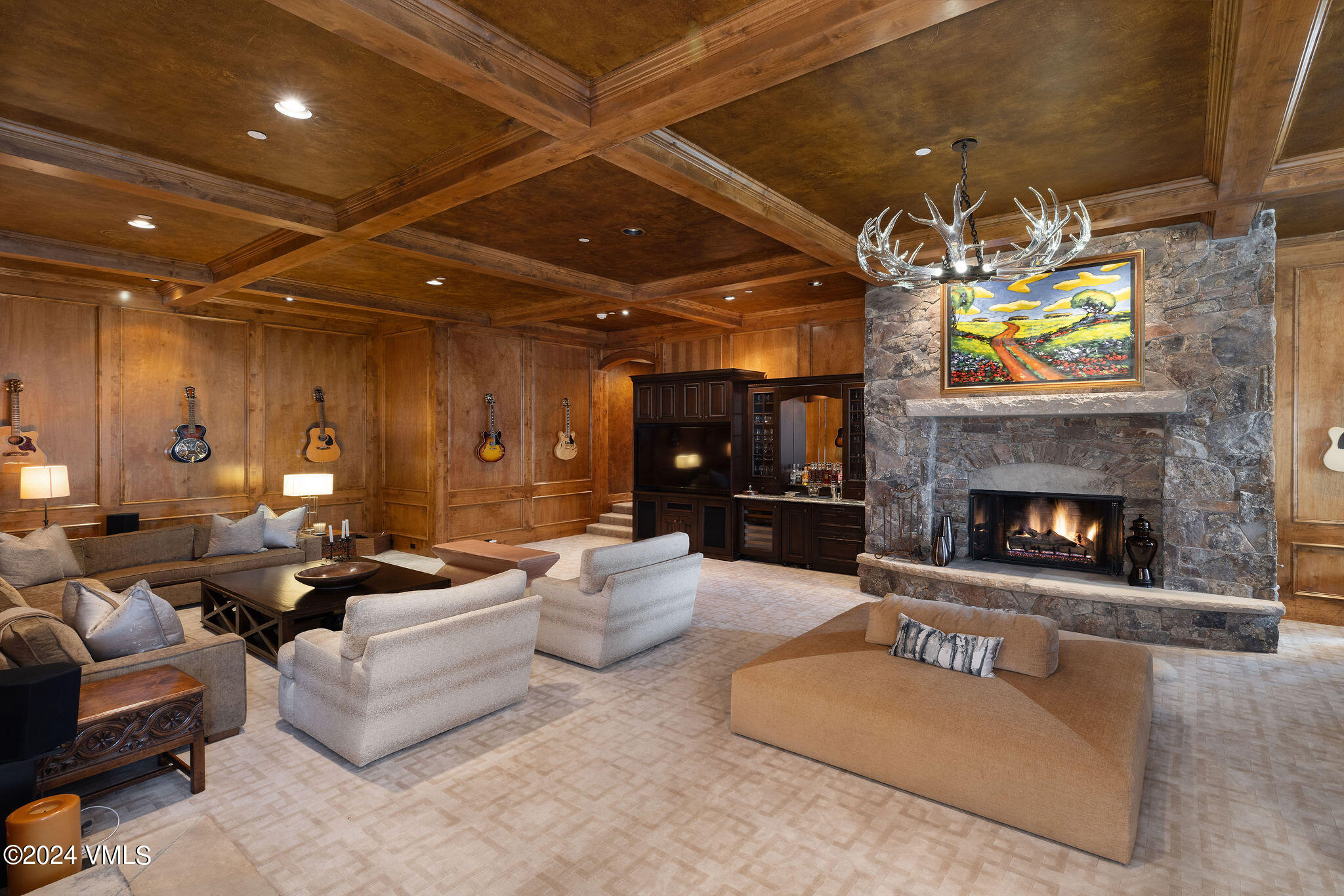 1101 Daybreak Ridge Road Avon, CO 81620 - Photo 20 of 30 a living room with furniture a fireplace and a chandelier
