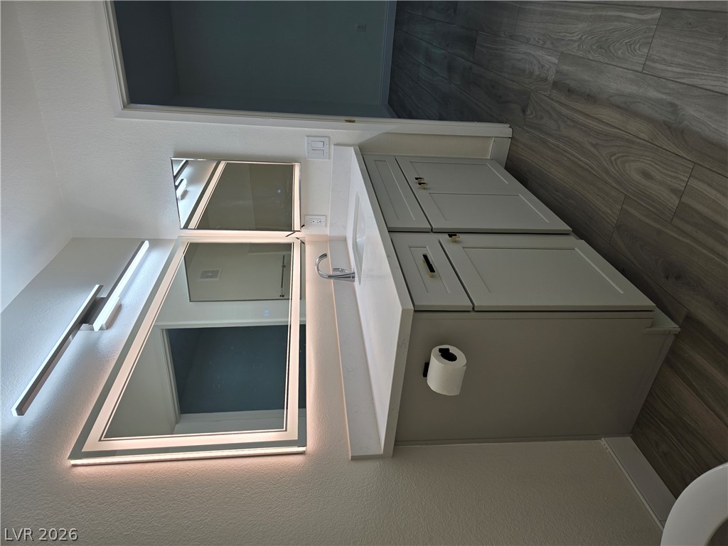 1881 West Alexander Road, Unit 1127 North Las Vegas, NV 89032 - Photo 12 of 20 Clean lines define this modern vanity, featuring sleek cabinetry and illuminated mirrors.