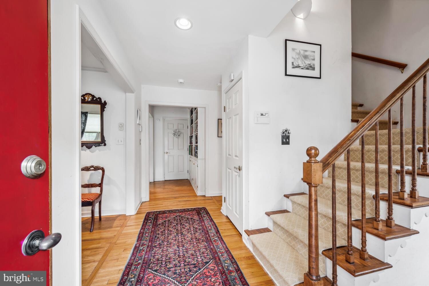 4260 Windrush Road Oxford, MD 21654 - Photo 22 of 39 a view of a hallway with wooden floor and stairs