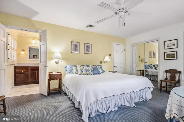 a bedroom with bed and wooden floor