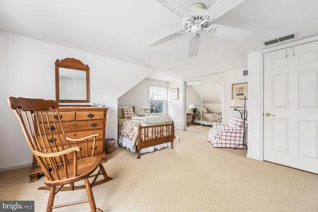 a living room with furniture a ceiling fan and a rug