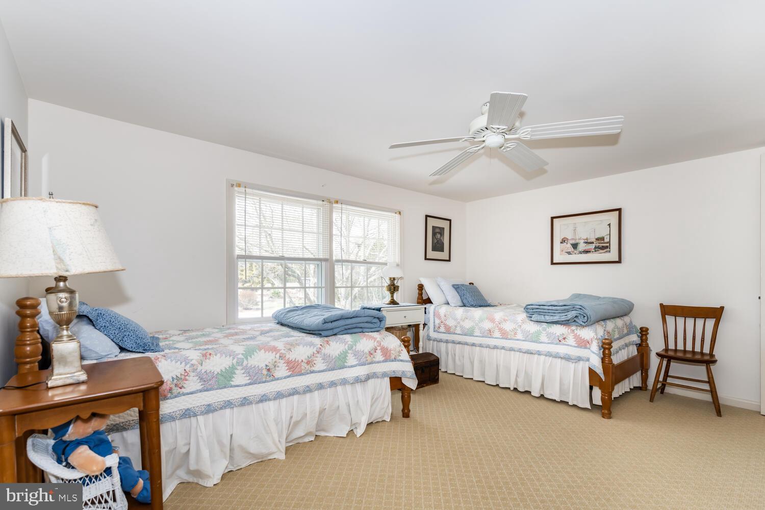 4260 Windrush Road Oxford, MD 21654 - Photo 36 of 39 a bedroom with bed and a chandelier