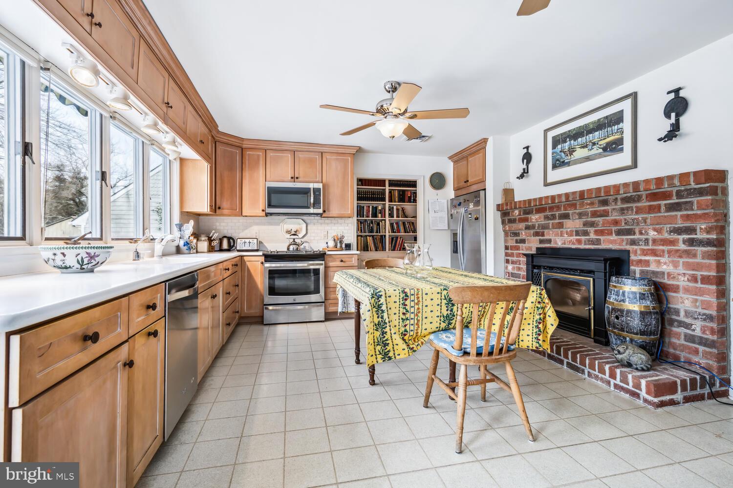 4260 Windrush Road Oxford, MD 21654 - Photo 5 of 39 a open kitchen with stainless steel appliances granite countertop a stove top oven a sink a dining table and chairs