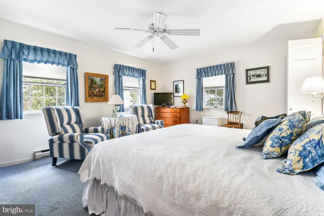 a bed room with a bed and a chair