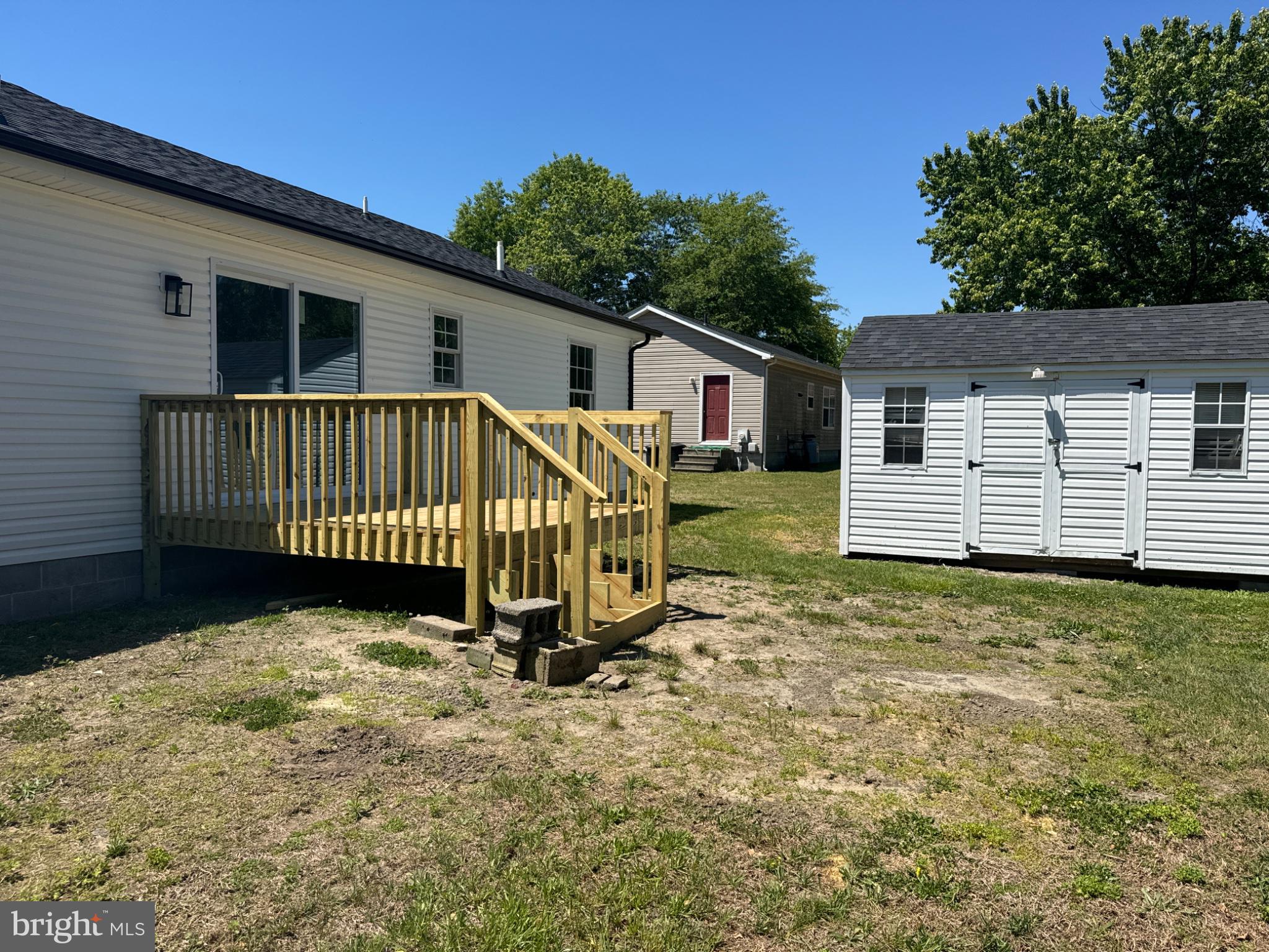 208 Oak Street Ellendale, DE 19941 - Photo 12 of 18 Sunny backyard with a welcoming deck.