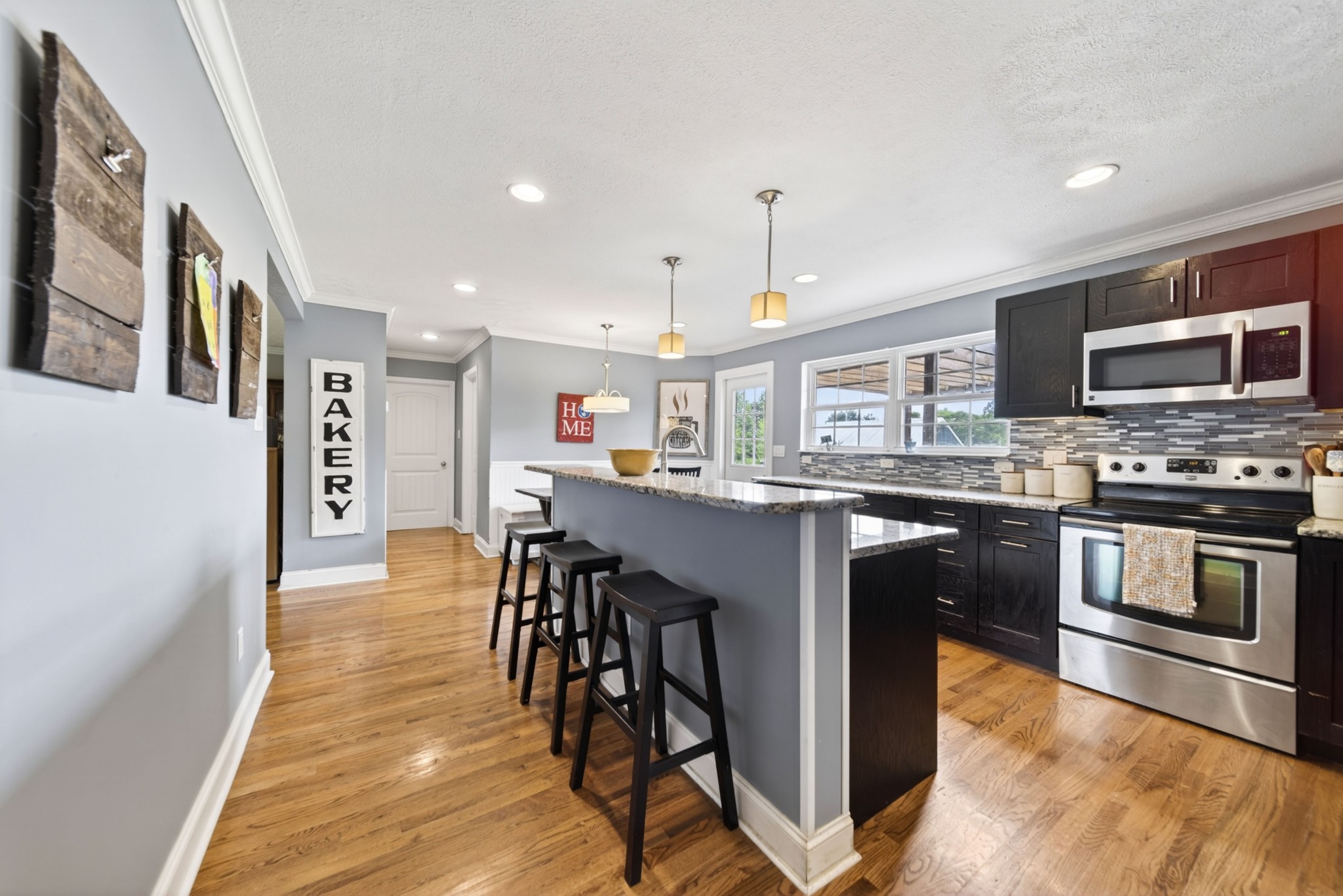 8023 Bethlehem Road Springfield, TN 37172 - Photo 31 of 55 a kitchen with stainless steel appliances granite countertop a stove top oven a sink dishwasher a refrigerator and a dining table with wooden floor