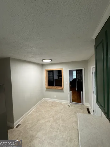 a bedroom with a bed window and a flat screen tv