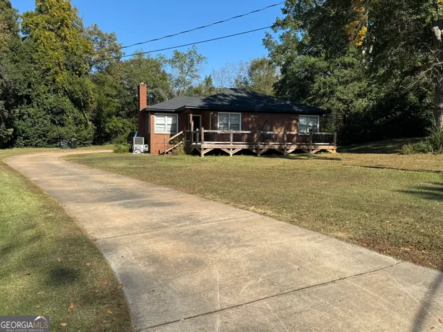 a view of house with outdoor space and swimming pool