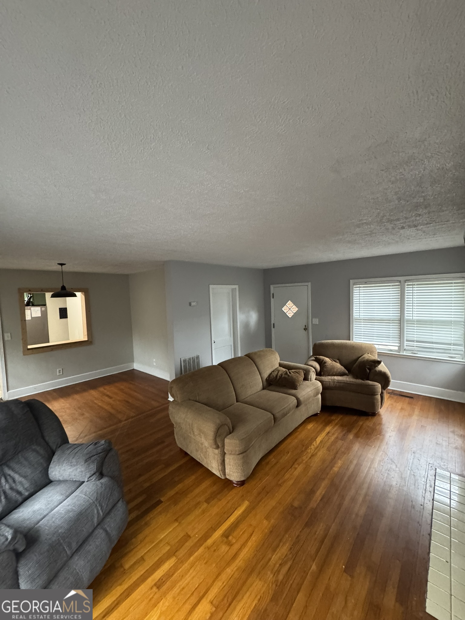 107 Springdale Drive Thomaston, GA 30286 - Photo 21 of 30 a living room with furniture and a wooden floor