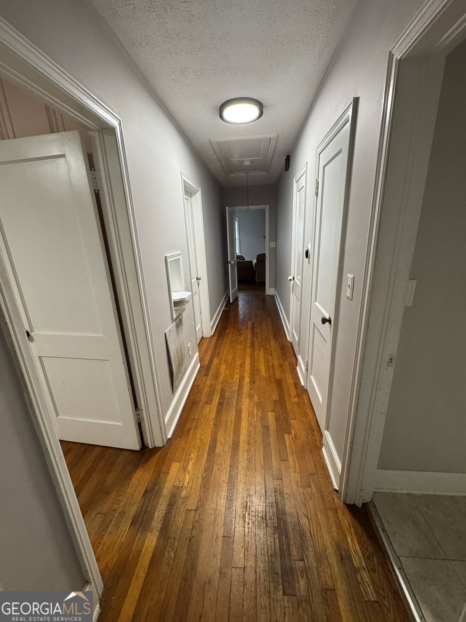 107 Springdale Drive Thomaston, GA 30286 - Photo 29 of 30 a view of a hallway with wooden floor and staircase