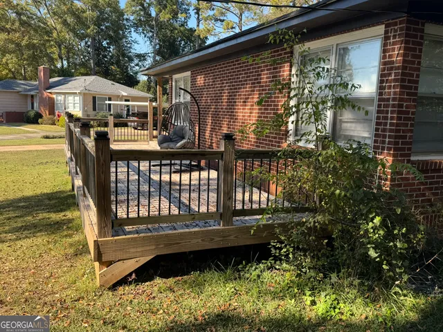 a view of a house with backyard space and sitting area