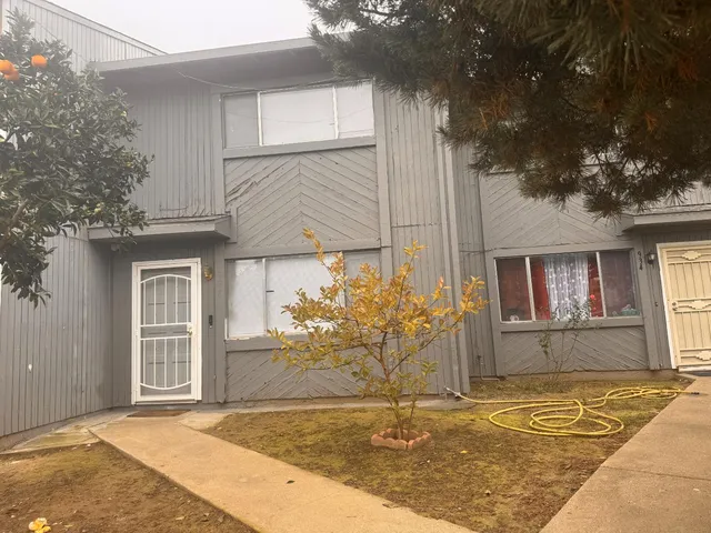 a kitchen with stainless steel appliances granite countertop a sink table and chairs