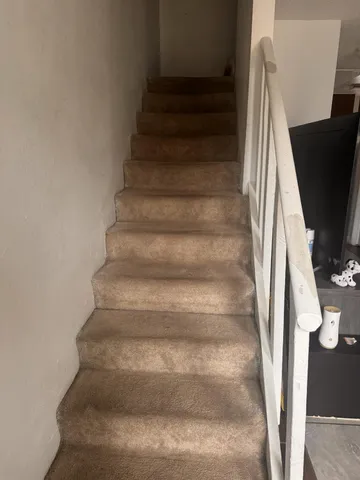 a kitchen with stainless steel appliances granite countertop a refrigerator and a stove