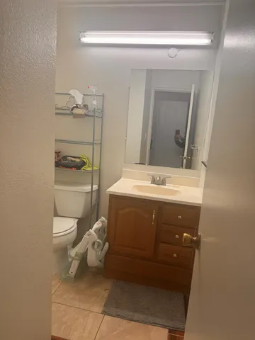 a bathroom with a toilet sink and mirror