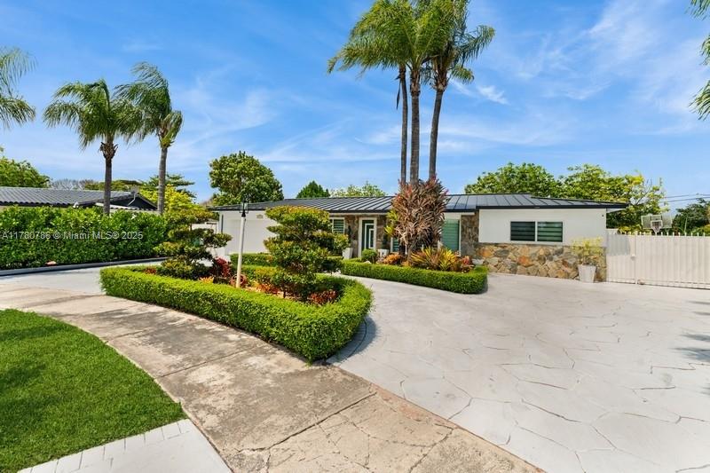 12555 Southwest 31st Street Miami, FL 33175 - Photo 1 of 47 a front view of a house with garden