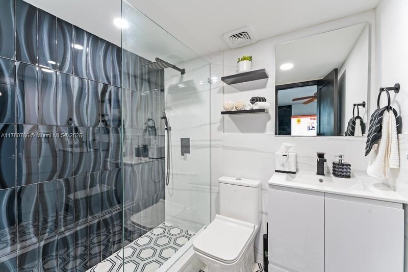 12555 Southwest 31st Street Miami, FL 33175 - Photo 20 of 47 a bathroom with a shower a sink a toilet and mirror