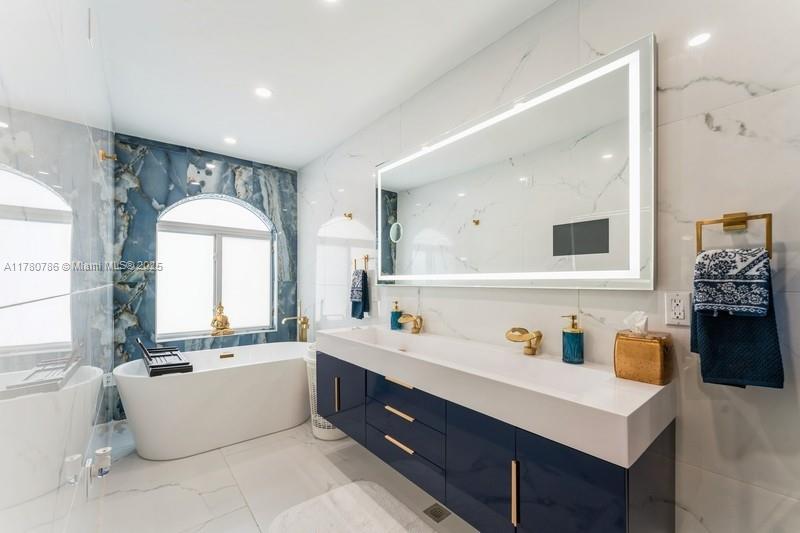 12555 Southwest 31st Street Miami, FL 33175 - Photo 26 of 47 a bathroom with a tub sink a mirror and vanity