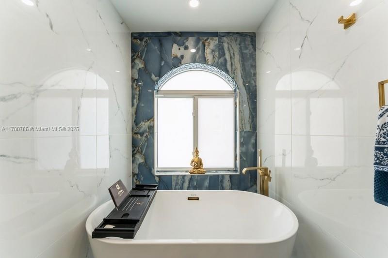 12555 Southwest 31st Street Miami, FL 33175 - Photo 27 of 47 a bathroom with a tub a sink and a large mirror