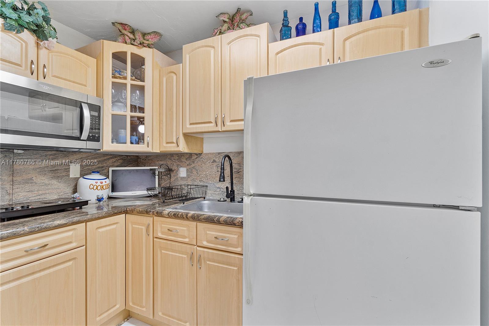 12555 Southwest 31st Street Miami, FL 33175 - Photo 30 of 47 a kitchen with stainless steel appliances white cabinets and a refrigerator