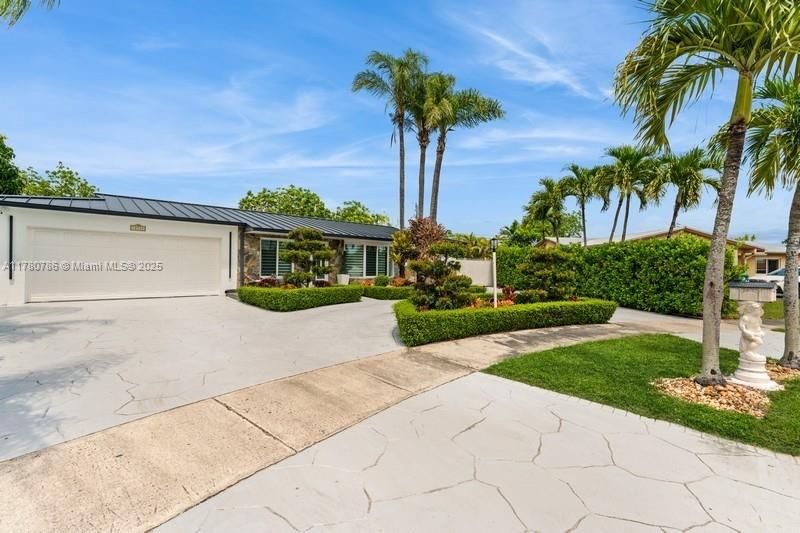 12555 Southwest 31st Street Miami, FL 33175 - Photo 32 of 47 a front view of a house with garden