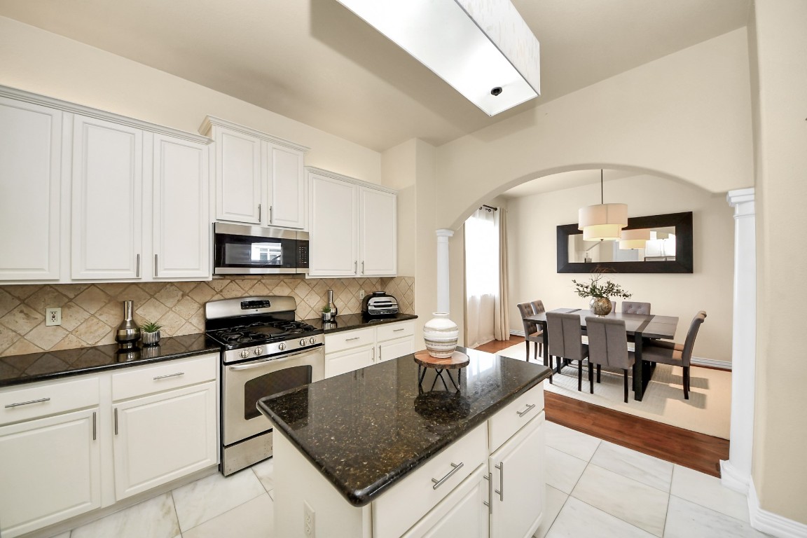 3507 Jackson Street Houston, TX 77004 - Photo 11 of 29 Bright, modern kitchen with a large island, ample cabinetry, and stainless-steel appliances, offering the ideal setup for hosting, meal prep, and casual dining.
