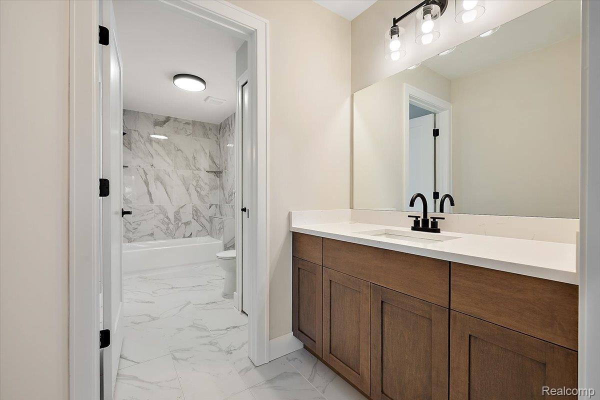 53650 Romeo Plank Road Macomb, MI 48042 - Photo 41 of 64 Bathroom with bathtub / shower combination, and vanity